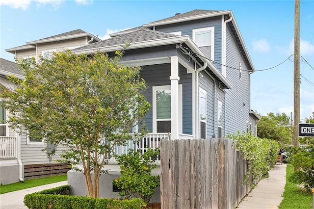 8501 Cohn St, New Orleans, LA 70118 - view of side of property with roof with shingles and fence