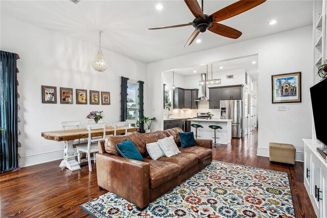 8501 Cohn St, New Orleans, LA 70118 - living area with baseboards, visible vents, ceiling fan with notable chandelier, and dark wood finished floors