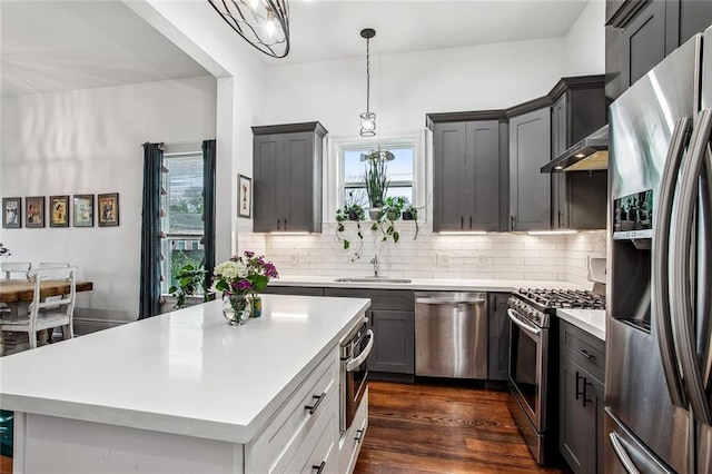 8501 Cohn St, New Orleans, LA 70118 - kitchen featuring dark wood-style flooring, light countertops, backsplash, and stainless steel appliances