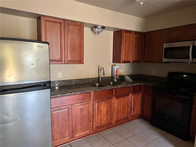 44154 Simpson Pl, Hammond, LA 70403 - kitchen featuring light tile patterned flooring, brown cabinetry, stainless steel appliances, and a sink