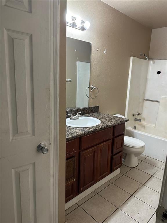 44154 Simpson Pl, Hammond, LA 70403 - full bathroom featuring tile patterned flooring, toilet, vanity, and tub / shower combination