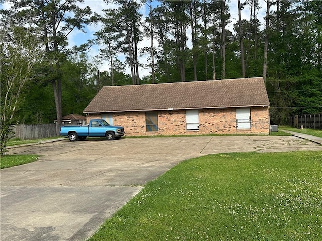 44176 Simpson Pl, Hammond, LA 70403 - view of home's exterior featuring fence, a shingled roof, brick siding, and a yard