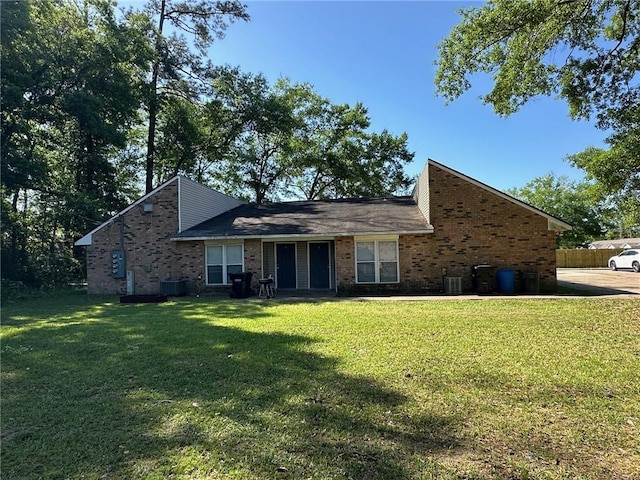 44176 Simpson Pl, Hammond, LA 70403 - view of front facade with central air condition unit, a front lawn, and brick siding