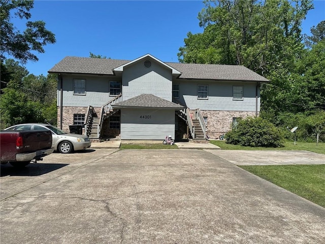 44301 Simpson Pl, Hammond, LA 70403 - view of front of house with brick siding, a front lawn, and stairs