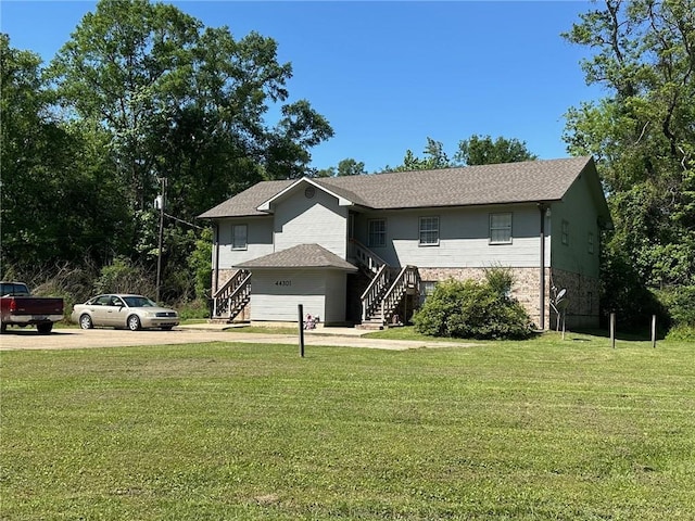 44301 Simpson Pl, Hammond, LA 70403 - raised ranch featuring concrete driveway, a front lawn, and stairway