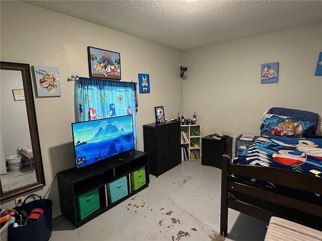 44301 Simpson Pl, Hammond, LA 70403 - bedroom with concrete floors and a textured ceiling