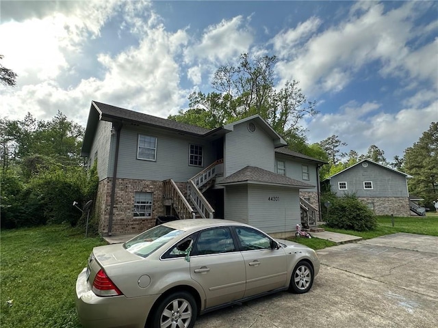 44301 Simpson Pl, Hammond, LA 70403 - view of front of home featuring brick siding, a front lawn, and stairway