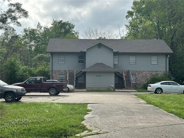 44301 Simpson Pl, Hammond, LA 70403 - view of front of home with a front lawn, stone siding, and stairs