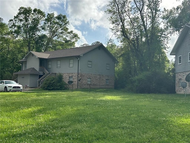 44301 Simpson Pl, Hammond, LA 70403 - view of side of property featuring stone siding and a yard
