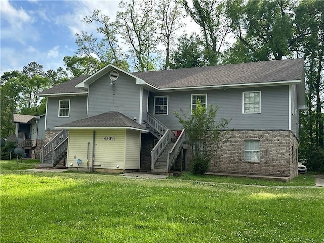 44321 Simpson Pl, Hammond, LA 70403 - rear view of property with brick siding, a lawn, a shingled roof, and stairway