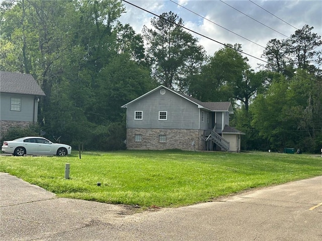 44321 Simpson Pl, Hammond, LA 70403 - view of side of home featuring a lawn, stairway, and stone siding