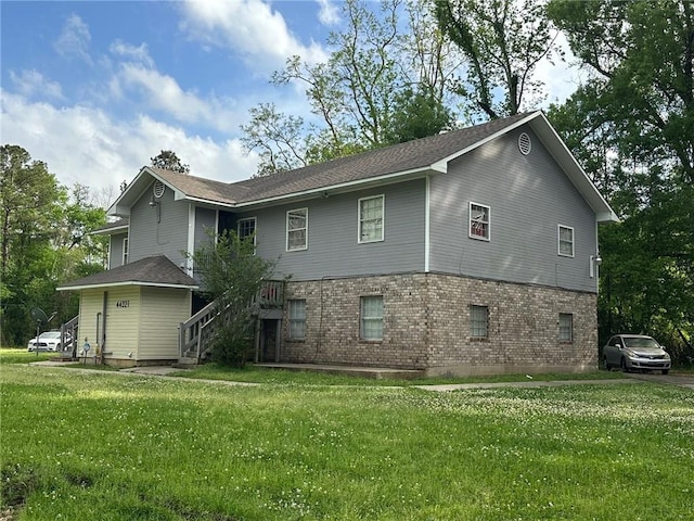 44321 Simpson Pl, Hammond, LA 70403 - back of property featuring stairs, brick siding, and a yard