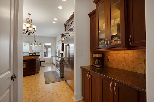 6021 W End Blvd, New Orleans, LA 70124 - kitchen featuring high end appliances, tasteful backsplash, a chandelier, dark stone countertops, and recessed lighting