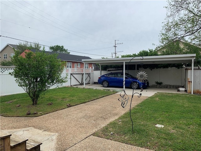 exterior space featuring an attached carport, a front yard, fence, and concrete driveway