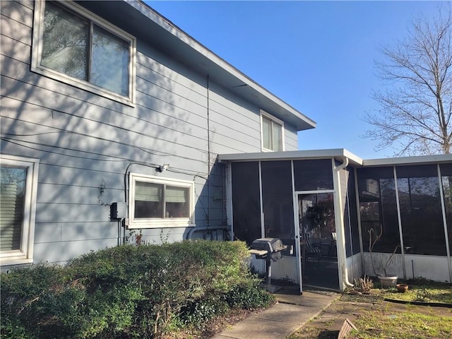 back of house with a sunroom