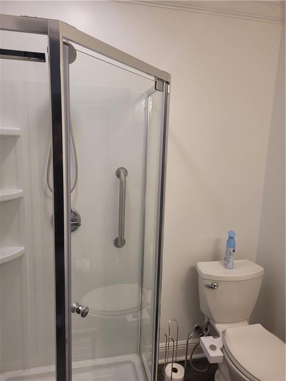full bath with toilet and a stall shower