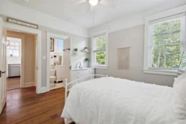 3015 Nashville Ave, New Orleans, LA 70125 - bedroom with baseboards, dark wood-style flooring, multiple windows, and a ceiling fan