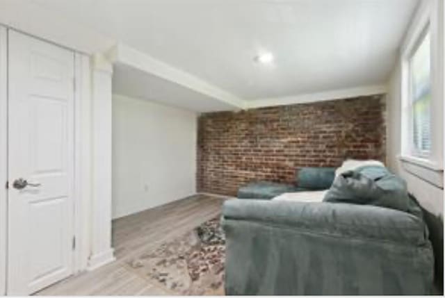 3015 Nashville Ave, New Orleans, LA 70125 - living area with brick wall, wood finished floors, and an accent wall