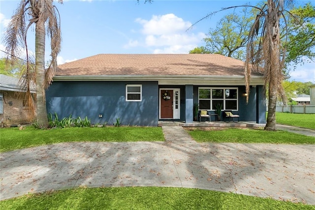 5601 Charlotte Dr, New Orleans, LA 70122 - ranch-style home with a porch, stucco siding, and a front lawn