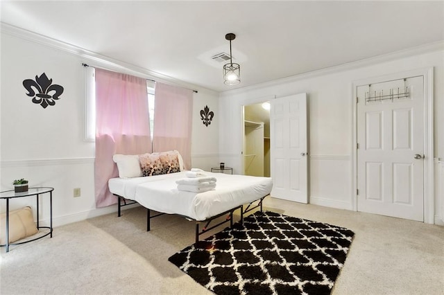 5601 Charlotte Dr, New Orleans, LA 70122 - carpeted bedroom with a walk in closet, crown molding, baseboards, and visible vents