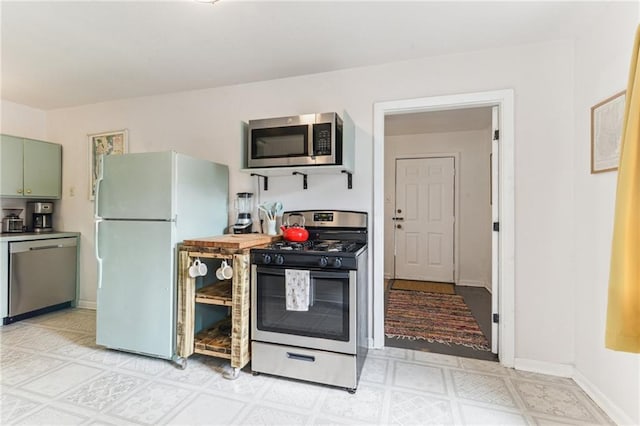 1524 N Dorgenois St, New Orleans, LA 70119 - kitchen featuring appliances with stainless steel finishes, light flooring, and baseboards