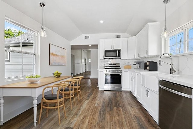 400 Fonda St, Paradis, LA 70080 - kitchen with backsplash, stainless steel appliances, dark wood-style floors, and vaulted ceiling