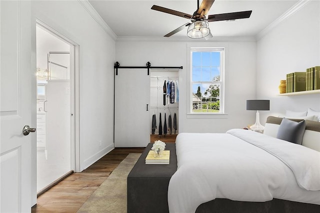 400 Fonda St, Paradis, LA 70080 - bedroom featuring crown molding, wood finished floors, a barn door, and ceiling fan
