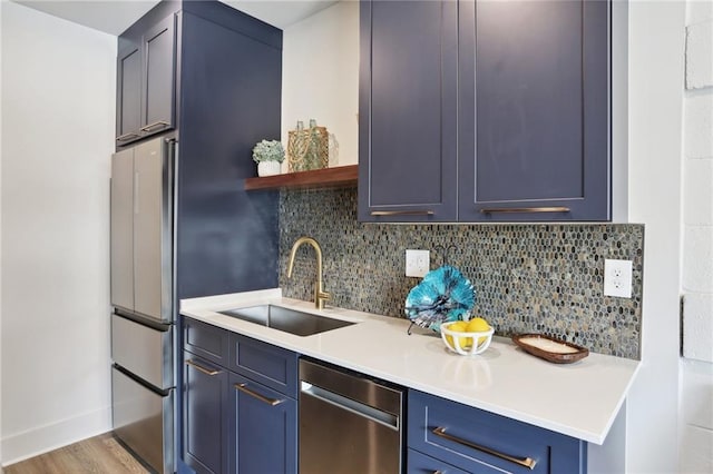1629 Washington Ave Unit 203, New Orleans, LA 70130 - kitchen with appliances with stainless steel finishes, a sink, decorative backsplash, and light countertops