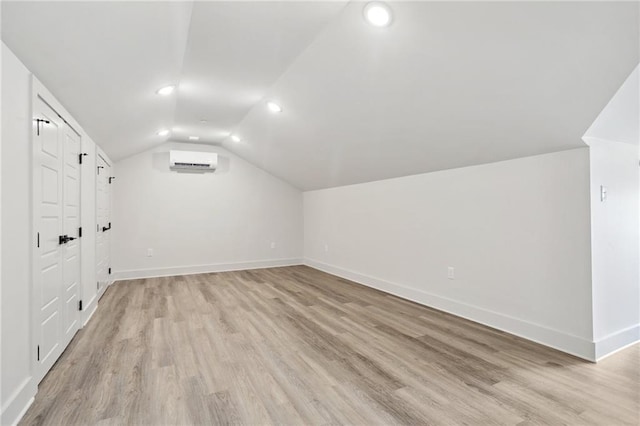 1629 Washington Ave Unit 203, New Orleans, LA 70130 - bonus room featuring a wall mounted air conditioner, light wood-type flooring, baseboards, lofted ceiling, and recessed lighting