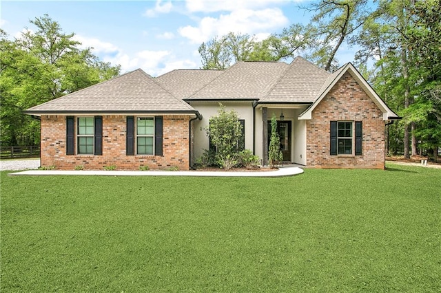 view of front of property with brick siding, a shingled roof, and a front lawn