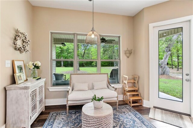 sitting room with baseboards and dark wood-style floors