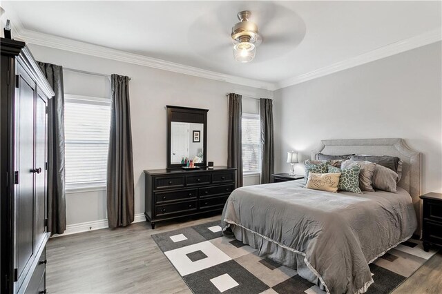 1904 Jena St, New Orleans, LA 70115 - bedroom featuring baseboards, ceiling fan, light wood-style flooring, and crown molding