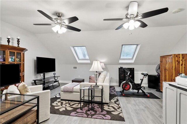 1904 Jena St, New Orleans, LA 70115 - living area with vaulted ceiling with skylight, light wood-style floors, and a ceiling fan