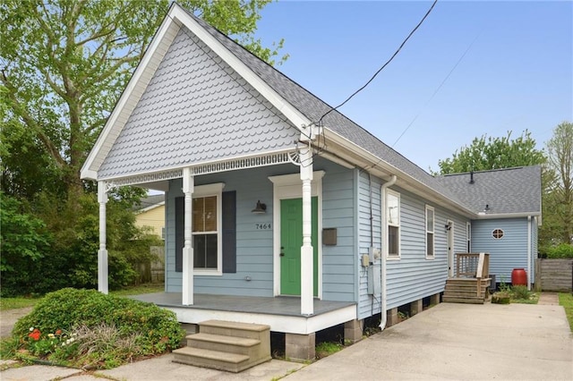 7464 Pitt St, New Orleans, LA 70118 - view of front of house with a porch and roof with shingles