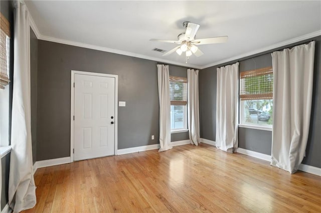 7464 Pitt St, New Orleans, LA 70118 - empty room featuring light wood finished floors, ornamental molding, and a ceiling fan
