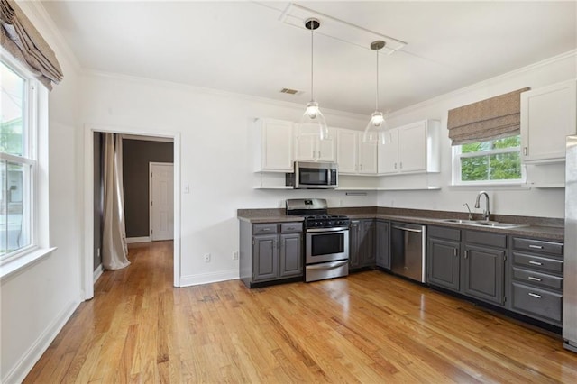 7464 Pitt St, New Orleans, LA 70118 - kitchen featuring stainless steel appliances, gray cabinetry, dark countertops, white cabinets, and ornamental molding