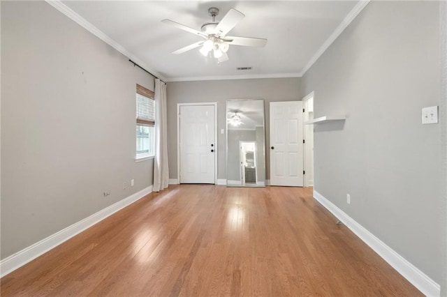 7464 Pitt St, New Orleans, LA 70118 - empty room featuring a ceiling fan, light wood-style floors, and crown molding