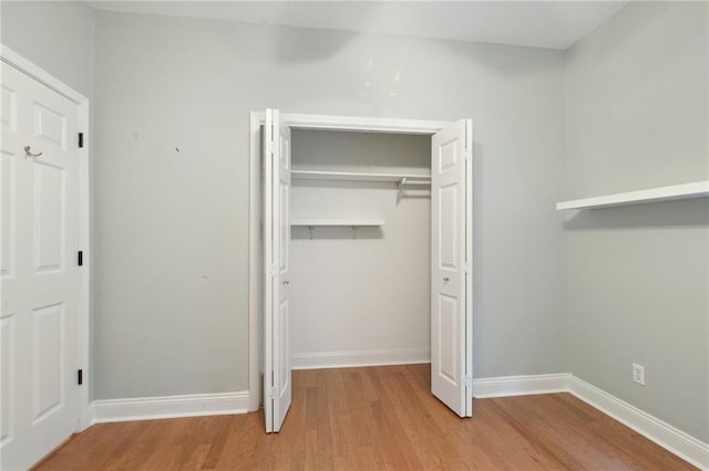 7464 Pitt St, New Orleans, LA 70118 - unfurnished bedroom featuring wood finished floors and a closet