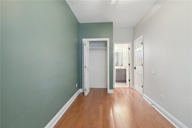 7464 Pitt St, New Orleans, LA 70118 - unfurnished bedroom with light wood-type flooring, connected bathroom, and a closet