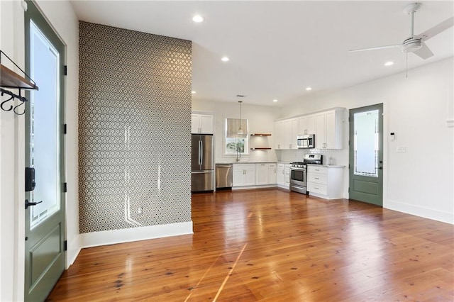 1217 N Tonti St, New Orleans, LA 70119 - unfurnished living room with a ceiling fan, light wood-style flooring, and recessed lighting