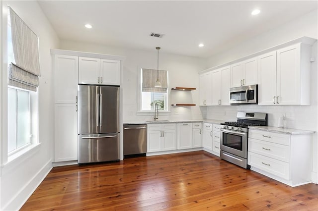 1217 N Tonti St, New Orleans, LA 70119 - kitchen with stainless steel appliances, open shelves, white cabinets, and recessed lighting