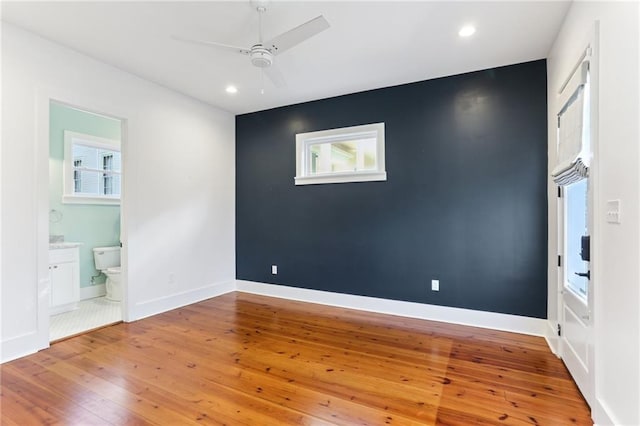 1217 N Tonti St, New Orleans, LA 70119 - unfurnished bedroom featuring hardwood / wood-style floors, recessed lighting, ensuite bathroom, and a ceiling fan