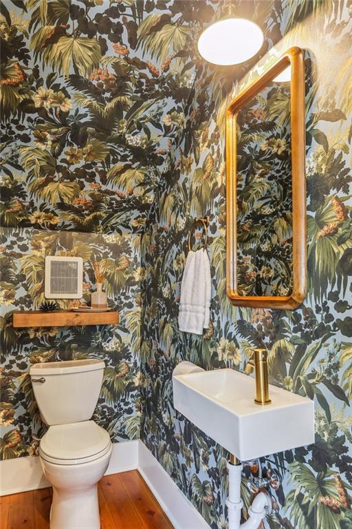 1217 N Tonti St, New Orleans, LA 70119 - bathroom featuring wallpapered walls and wood finished floors
