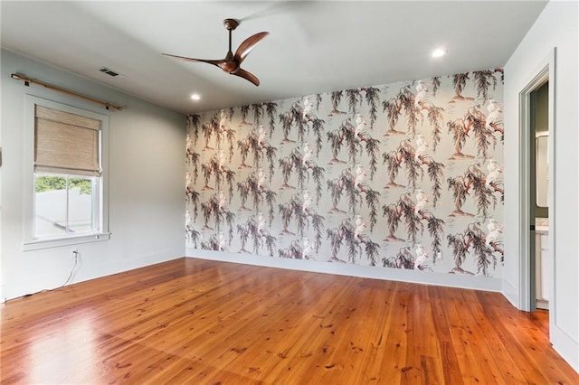 1217 N Tonti St, New Orleans, LA 70119 - spare room featuring wood-type flooring, ceiling fan, recessed lighting, and an accent wall