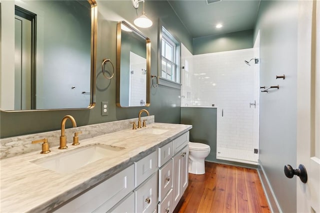 1217 N Tonti St, New Orleans, LA 70119 - bathroom featuring a stall shower, double vanity, and hardwood / wood-style flooring