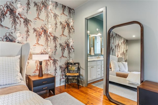 1217 N Tonti St, New Orleans, LA 70119 - bedroom featuring wood finished floors and connected bathroom