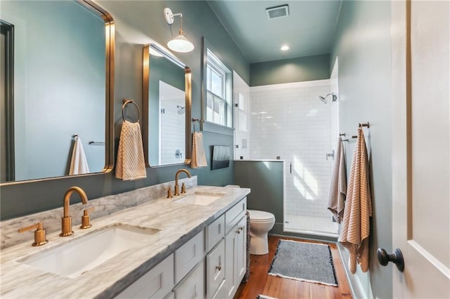 1217 N Tonti St, New Orleans, LA 70119 - full bathroom with a stall shower, double vanity, and wood finished floors