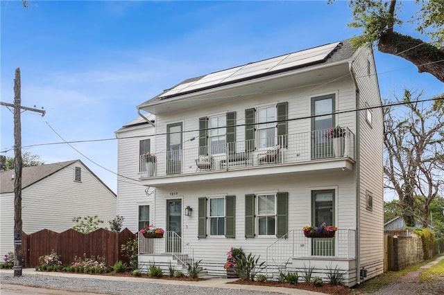 1217 N Tonti St, New Orleans, LA 70119 - view of front of property with a balcony and roof mounted solar panels