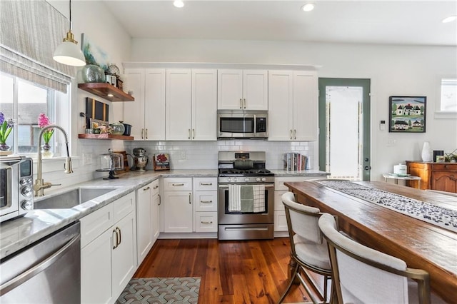 1217 N Tonti St, New Orleans, LA 70119 - kitchen with appliances with stainless steel finishes, open shelves, white cabinets, pendant lighting, and decorative backsplash
