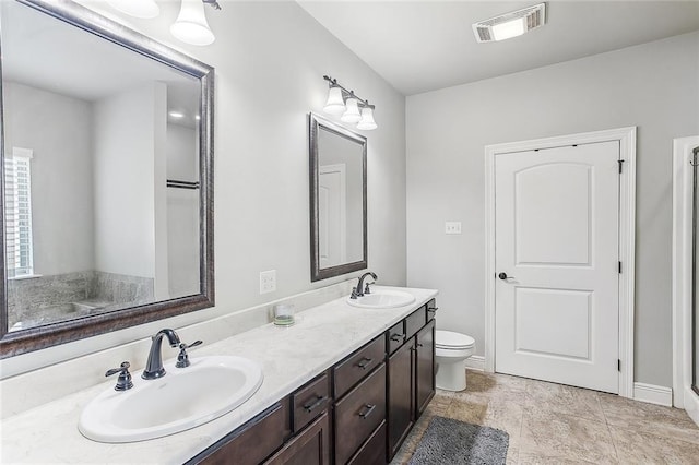 516 Tallow Tree Dr, Madisonville, LA 70447 - bathroom with toilet, double vanity, a sink, and visible vents